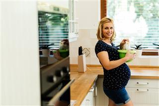 Pregnant woman working in kitchen