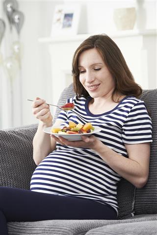 Pregnant Woman Eating Healthy Fruit Salad