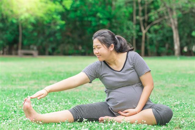 Pregnant woman work out in the garden