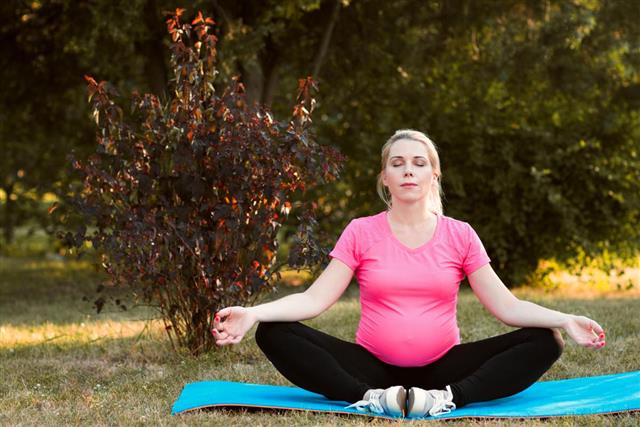 Pregnant woman meditate outdoor