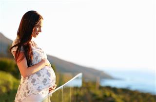 Pregnant young woman outdoors on a sunny day