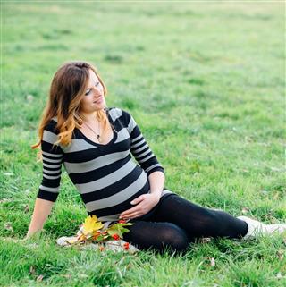 The pregnant girl in a field