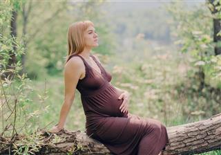 Pregnant woman sitting in the park