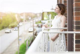 Beautiful pregnant woman on the balcony