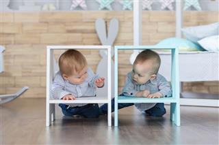 Boy twins playing on the floor
