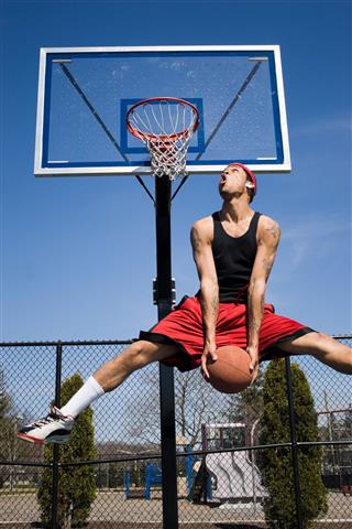 Man Dunking Basketball