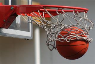 A Basketball Dropping Through A Net