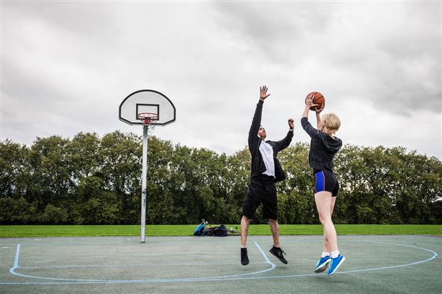 Man And Woman Playing Basketball