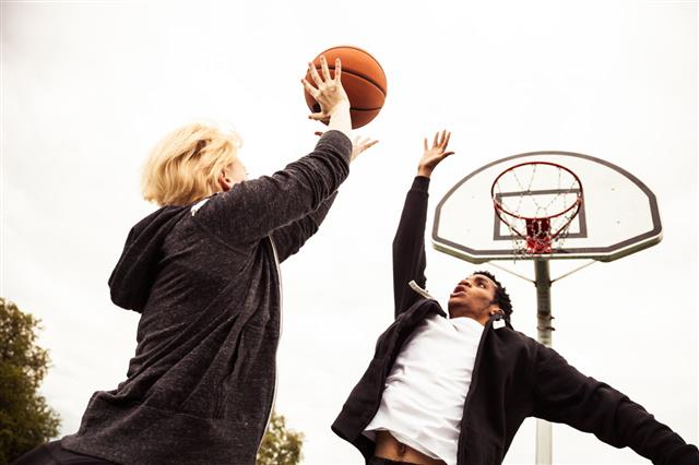 Man And Woman Playing Basketball