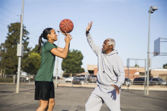 Father And Daughter Playing Basketball