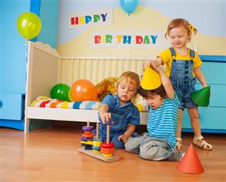 Boys and girl playing on birthday party