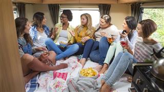 Group of Friends Relaxing in Caravan