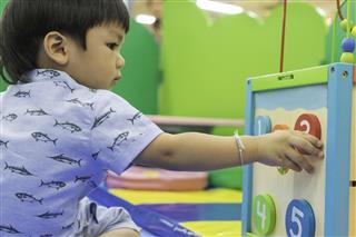 Asian Boy playing with Educational toys