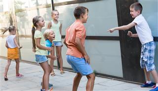 Active children playing charades outdoors