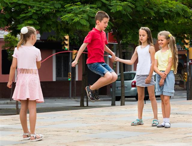 Children with jumping rope at playground