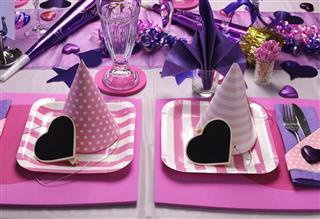 Two pink and purple party place settings