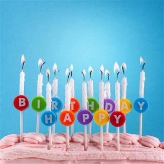 Happy birthday candles on blue background