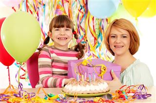 Happy daughter and mother with gift birthday party