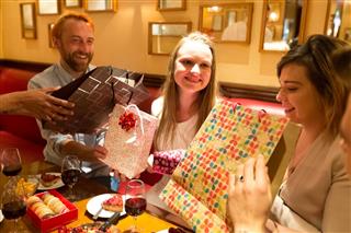 Group of Friends Giving Gifts to the Birthday Girl