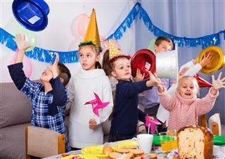 Boys and girls behaving jokingly during friend??s birthday party