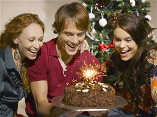 Friends looking at birthday cake