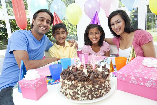 Asian Indian Family Celebrating Birthday Party With Chocolate Cake