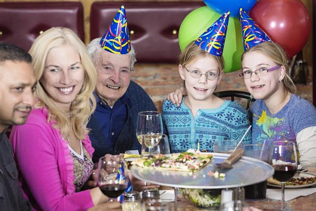 Group of People Celebrating Birthday at Pizza Restaurant