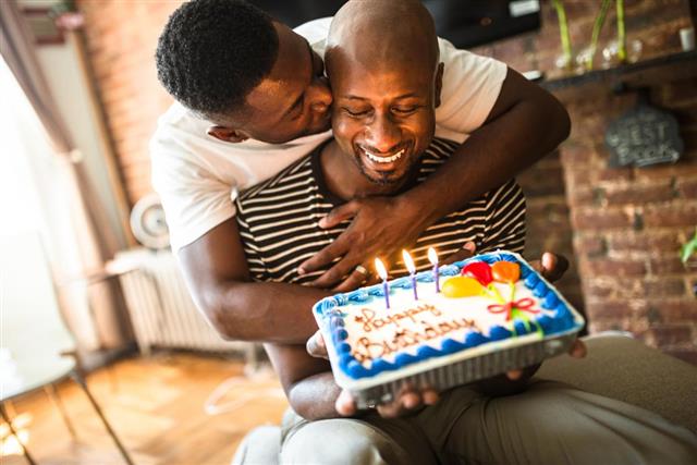 Homosexual couple share the kiss for the birthday