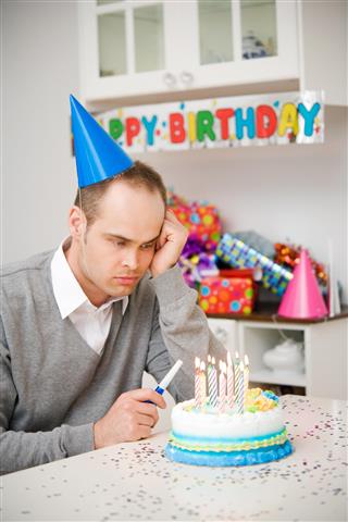 Sad Man Birthday Party with Cake and Candles