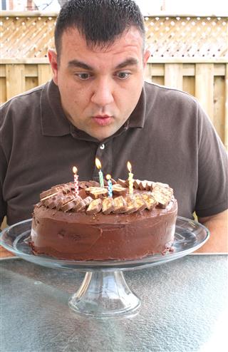 Man Blows Out The Candles