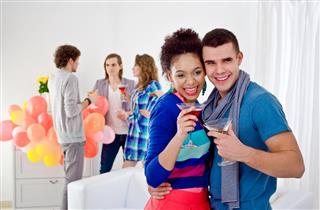 Young adult couple at home party