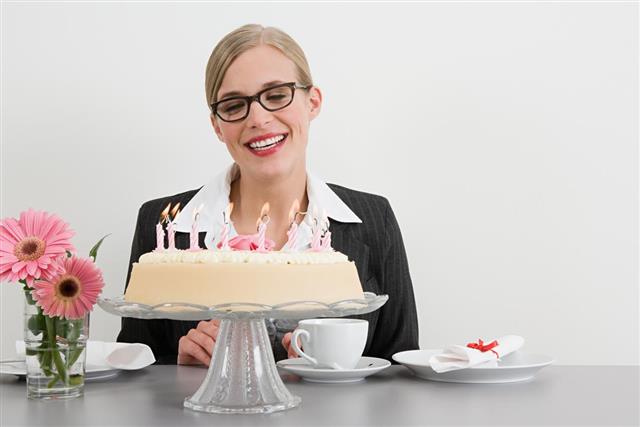 Businesswoman with birthday cake