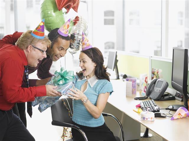 Businessmen giving birthday gift to co-worker