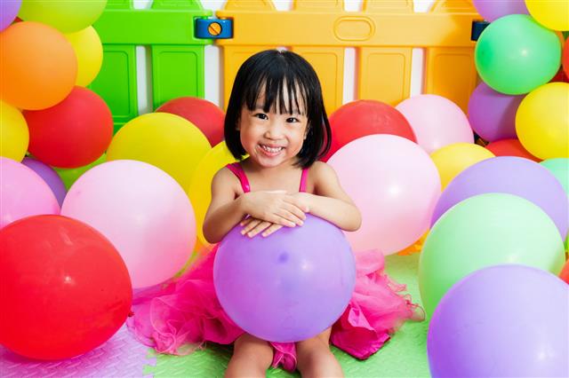 Girl Playing With Colorful Balloons