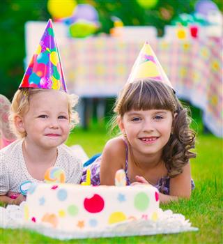 Two pretty little girls celebrating birthday