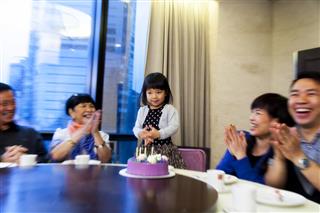 Asian family celebrating a birthday