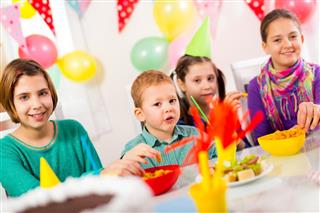 Group of adorable kids having fun at birthday party