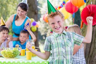 Birthday boy wearing party hat