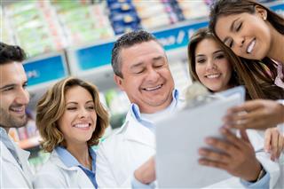 Group Of Pharmacists At The Drugstore