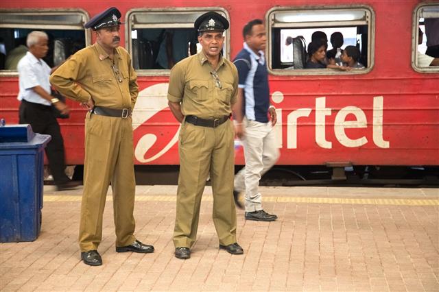 Policemen Standing At The Train Station
