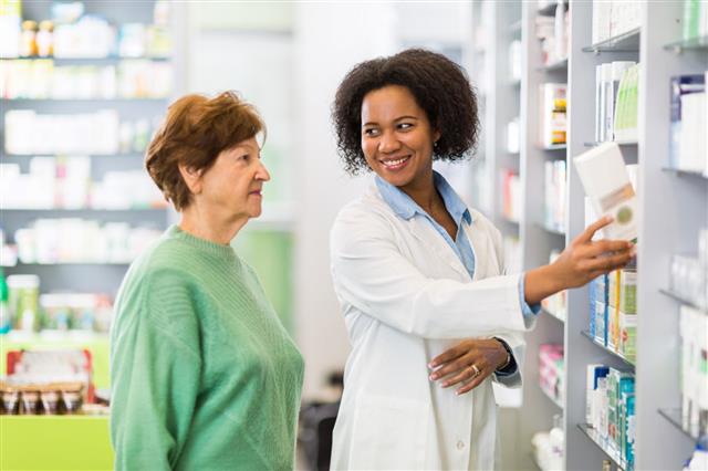 Pharmacist Assisting To A Senior Woman