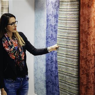 Interior Designer Looking At Fabrics