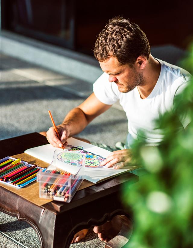 Man Coloring With Pencils