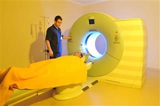 Technician Performing Medical Scan To Patient