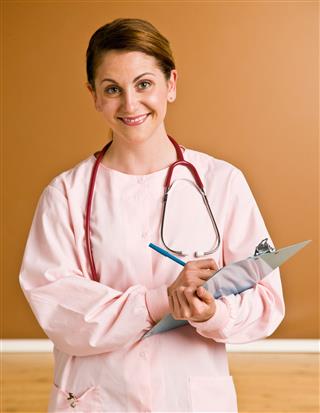 Nurse Writing On Clipboard