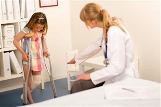 Pediatrician Little Girl With Crutches
