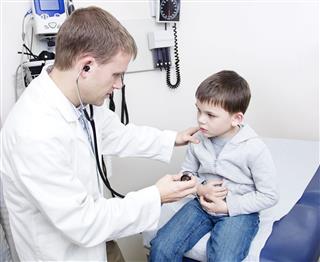 Doctor Examining Sick Little Boy
