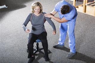 Physical Therapist Working With Patient