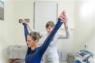 Patient Doing Pilates With Physical Therapists
