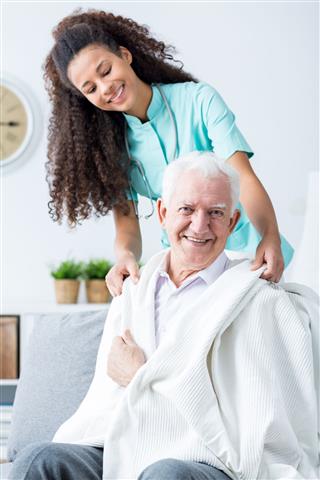 Nurse Supporting Ill Old Man